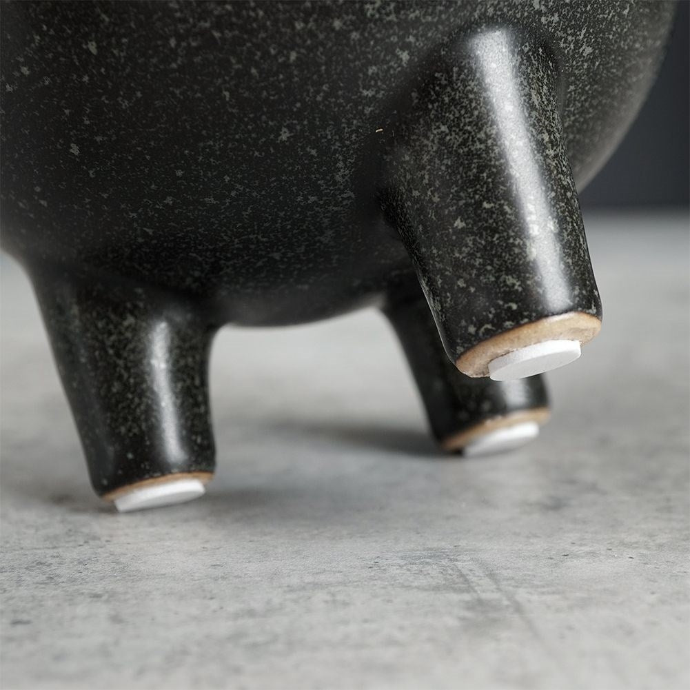 Elegant ceramic pot on legs with black, dotted pattern