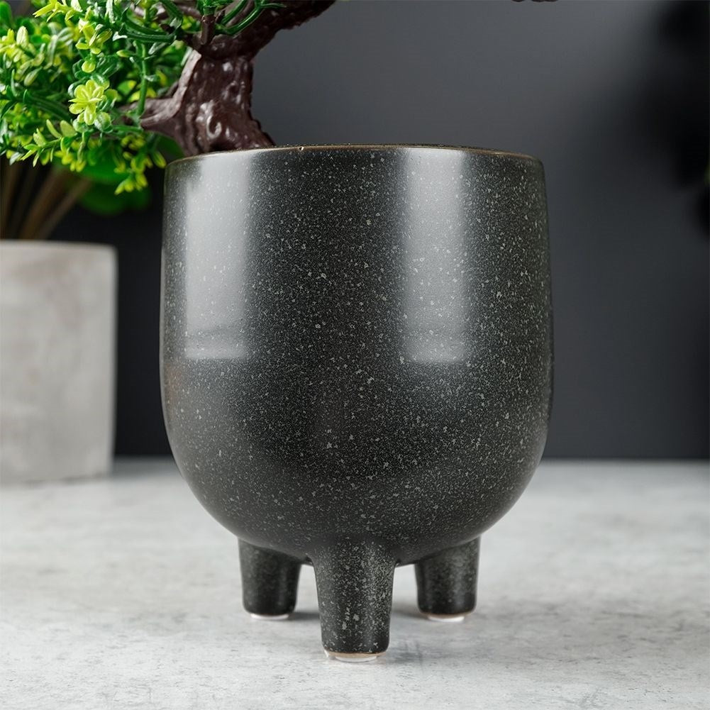 Elegant ceramic pot on legs with black, dotted pattern