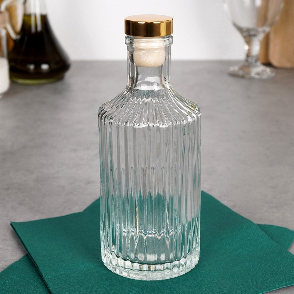 Elegant glass bottle with golden cork for drinks