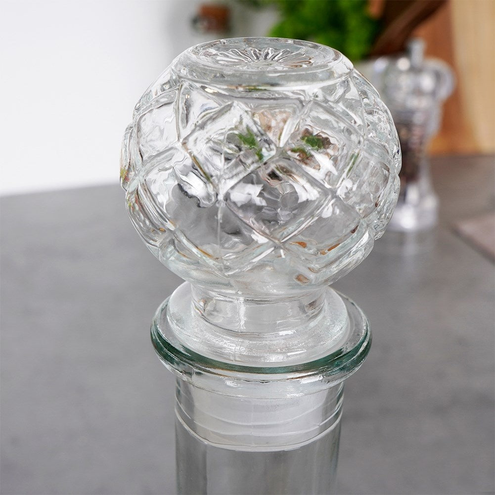 Elegant glass decanter with round cork for drinks and alcohol