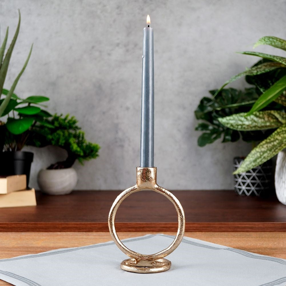 Elegant golden candlestick in classic style for long candles
