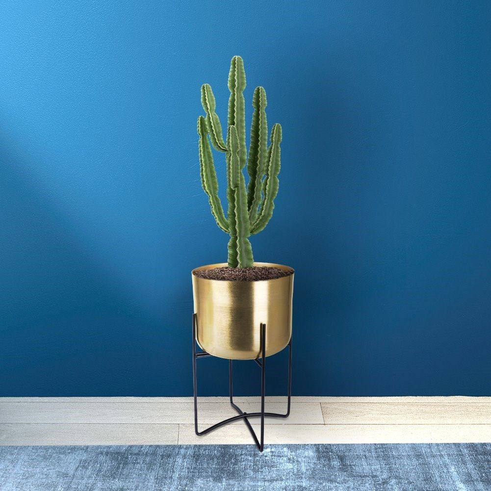 Elegant gold flower pot on black metal stand for modern interior design