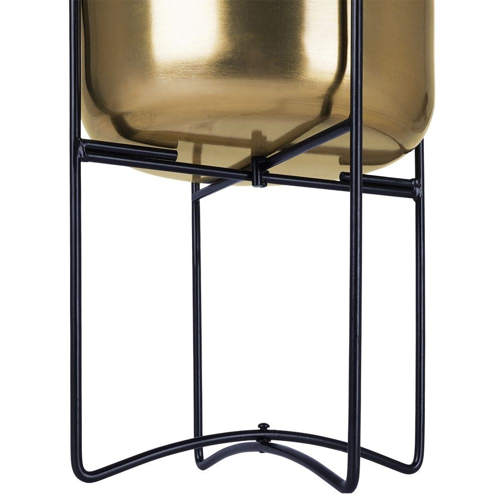 Elegant gold flower pot on black metal stand for modern interior design