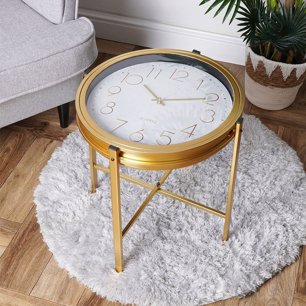 Elegant metal coffee table with built-in clock and golden finish