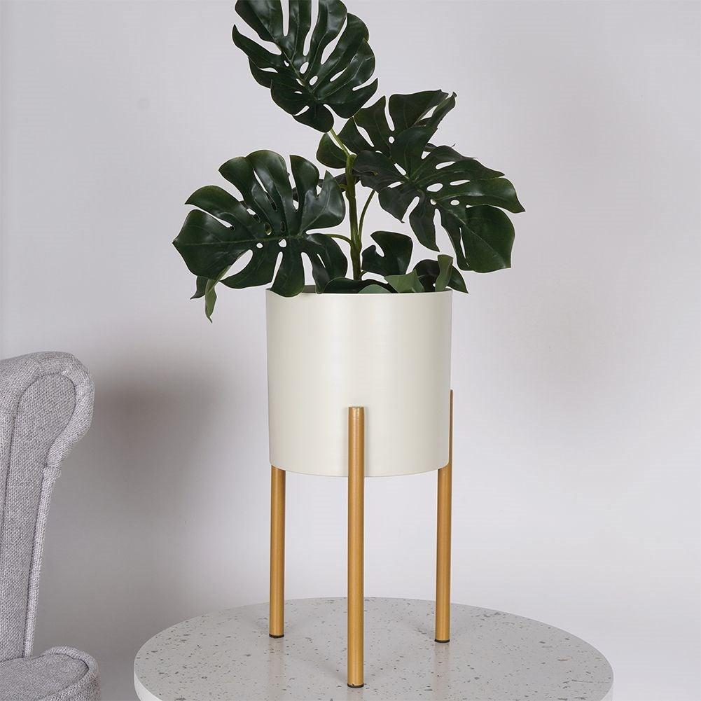 Elegant metal pot on stand in cream and gold