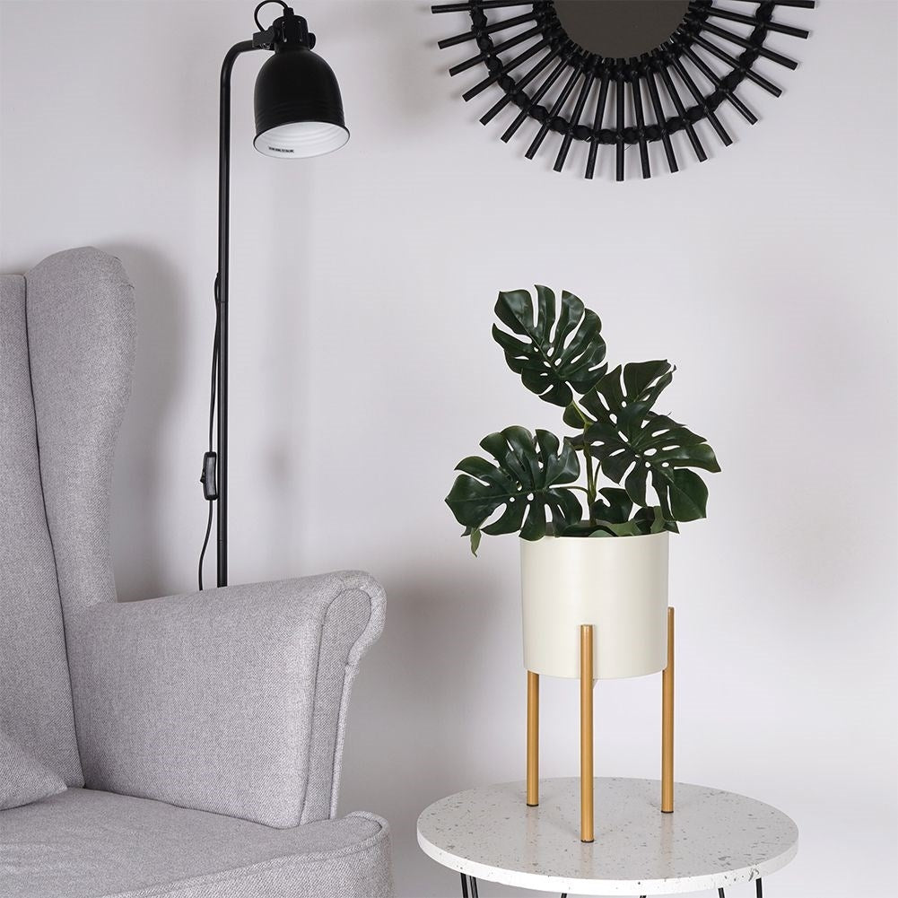 Elegant metal pot on stand in cream and gold