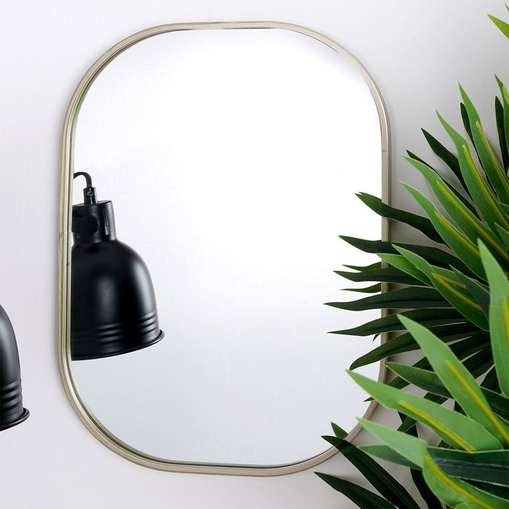 Elegant oval wall mirror with champagne gold metal frame