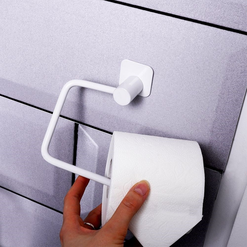 Elegant white metal toilet paper holder with mounting details