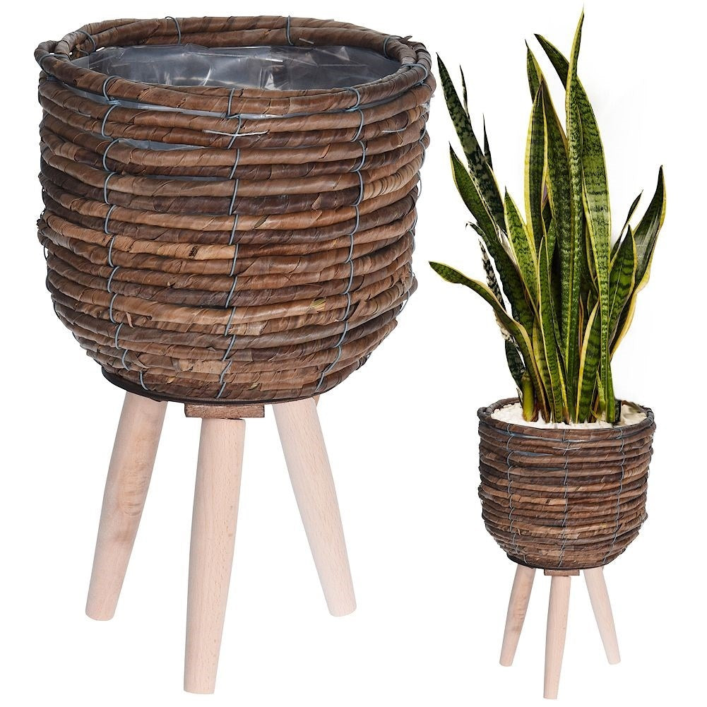 Flower pot on wooden legs. Braided from natural materials