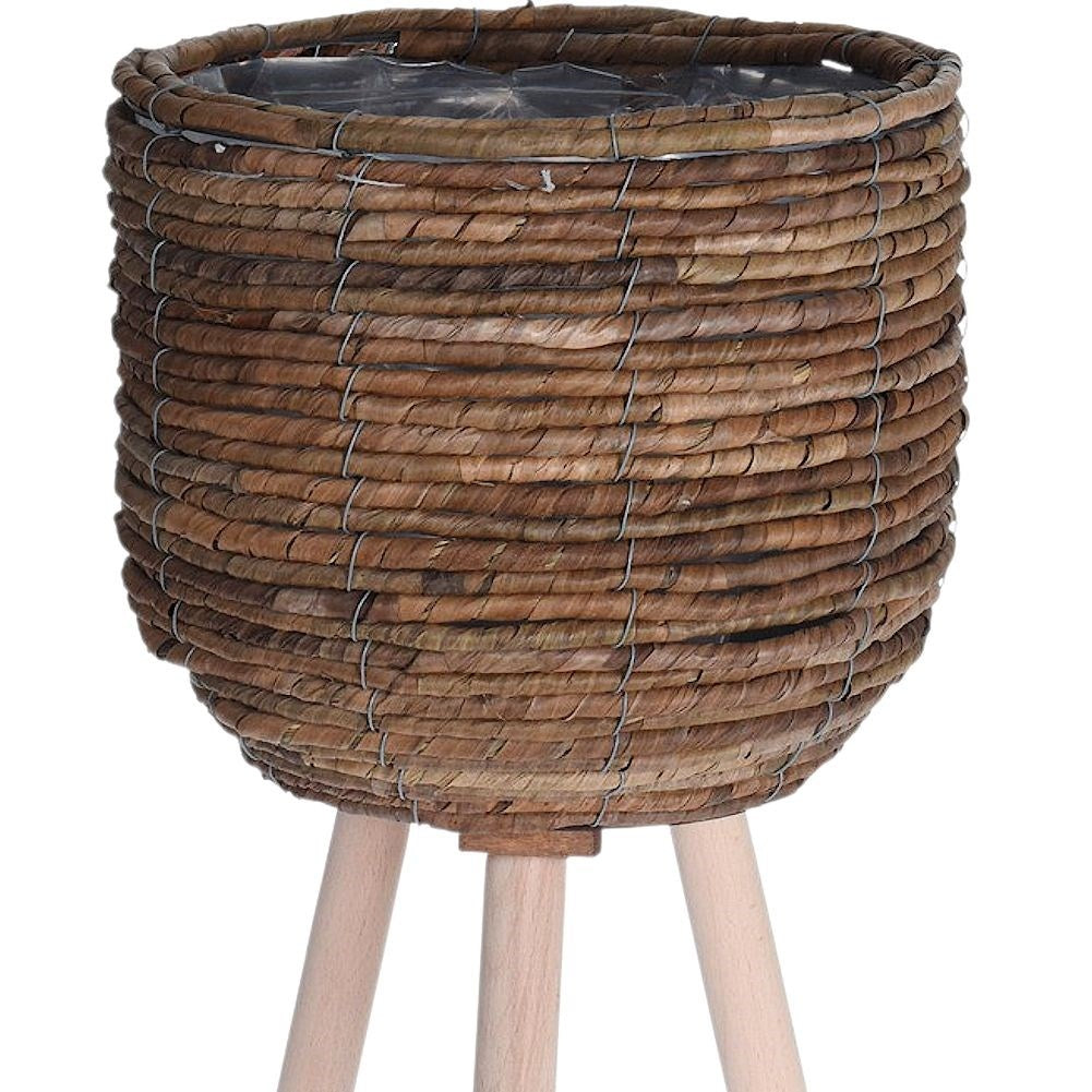 Flower pot on wooden legs, braided from natural materials