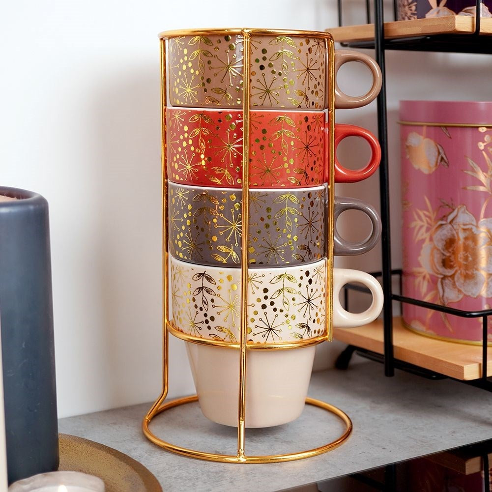 Four elegant porcelain mugs with gold stands and details