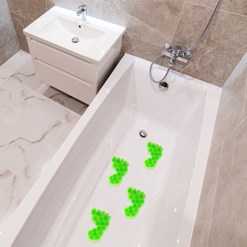 Four green non-slip mats with suction cups for shower/bathtub