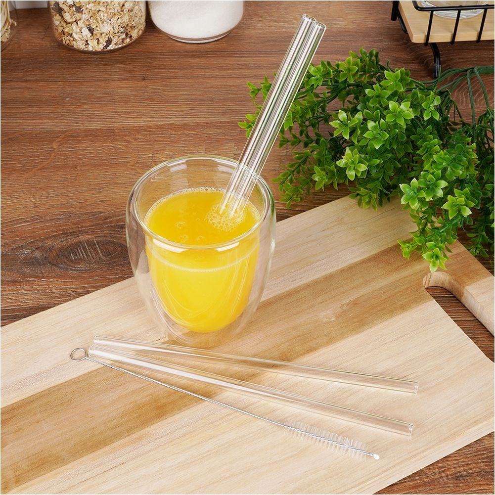 Four reusable glass straws with cleaning brush