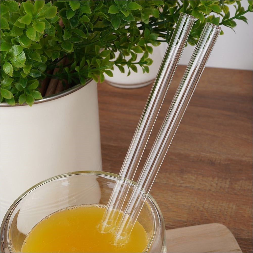 Four reusable glass straws with cleaning brush
