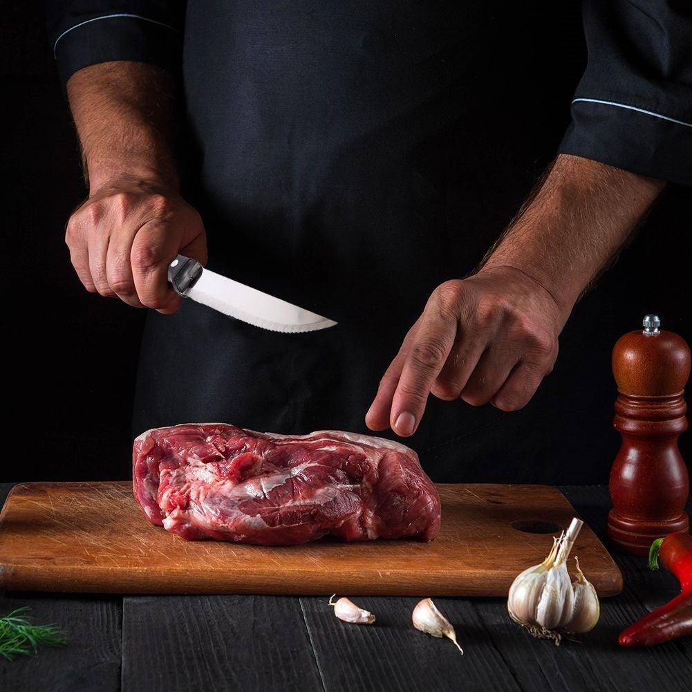 Four steak knives with serrated blades and comfortable handles