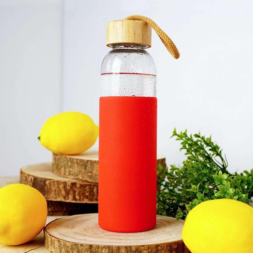 Glass bottle with silicone cover and wooden cork for drinks