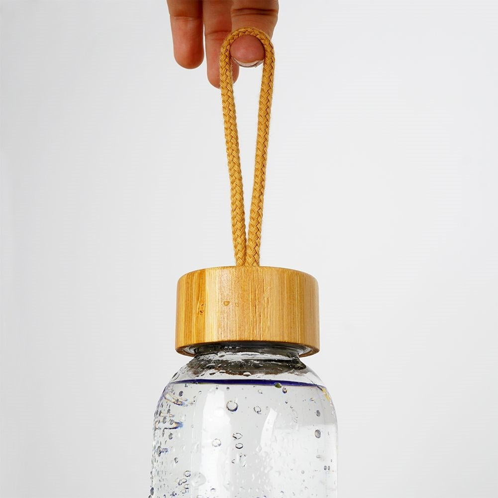 Glass bottle with silicone cover and wooden cork for drinks