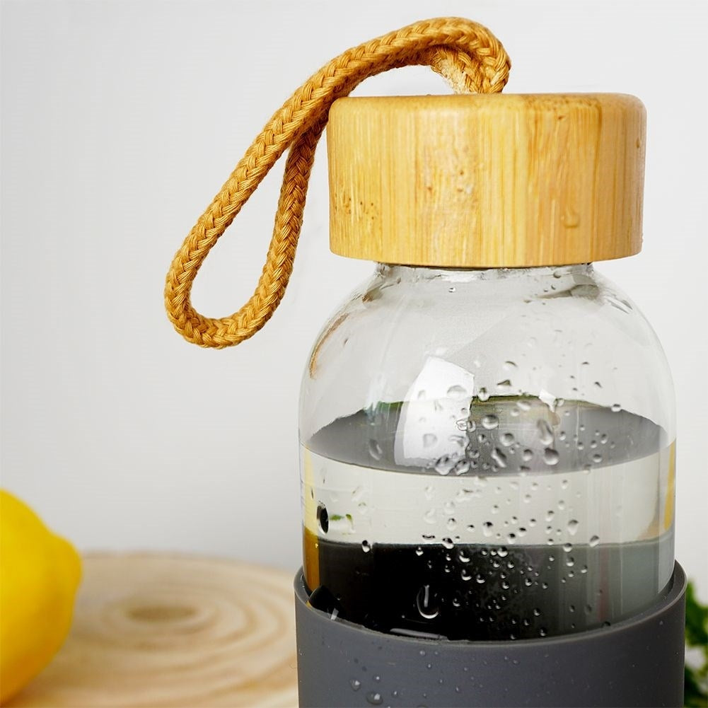 Glass bottle with silicone cover and wooden cork for drinks
