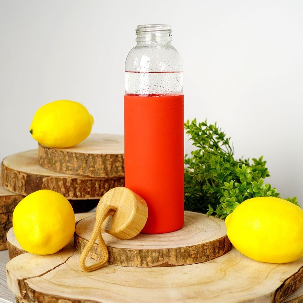 Glass bottle with silicone cover and wooden cork for drinks