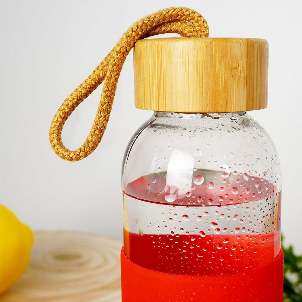 Glass bottle with silicone cover and wooden cork for drinks