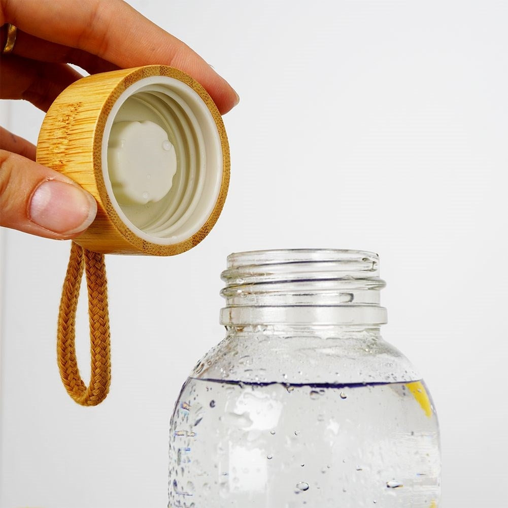 Glass bottle with silicone cover and wooden lid