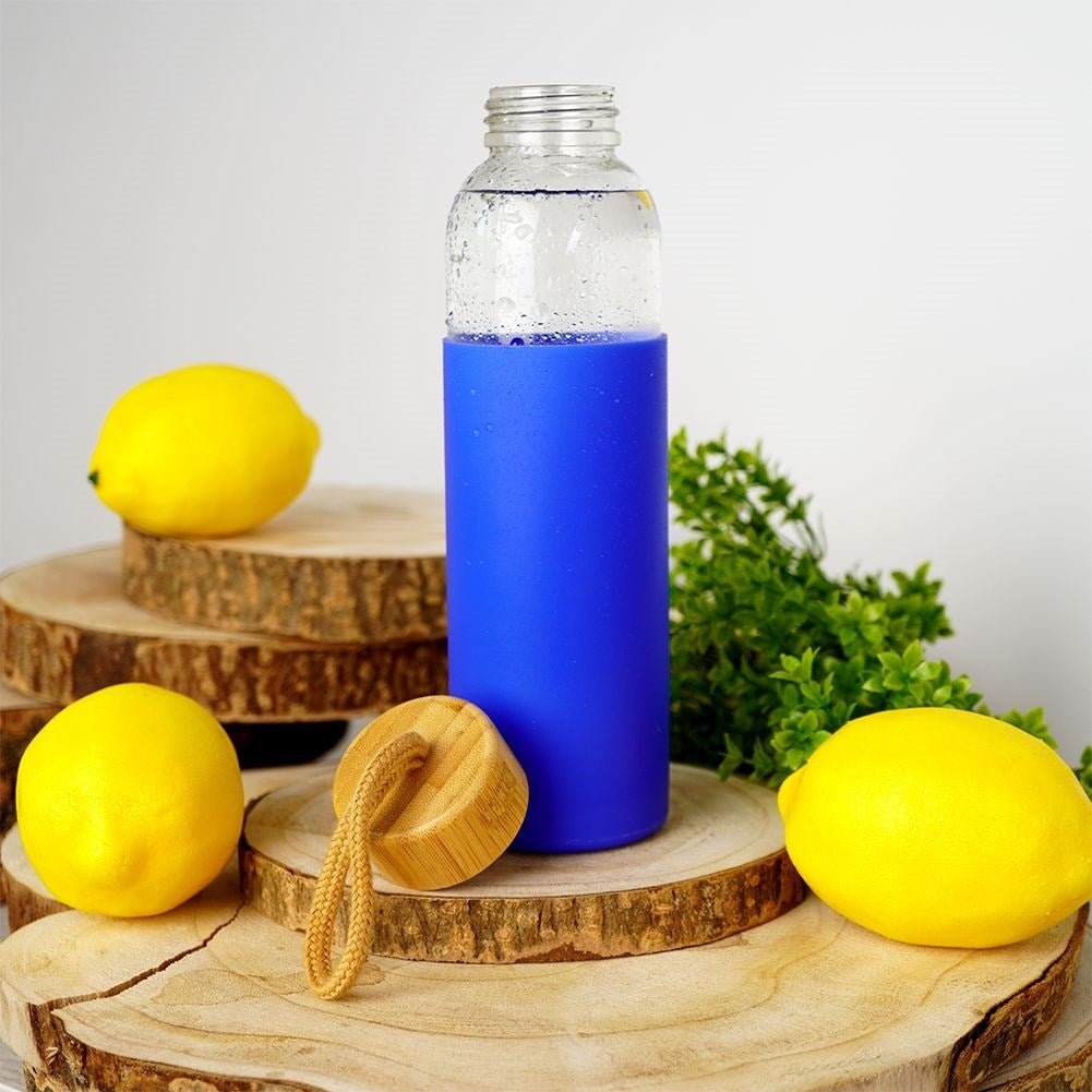 Glass bottle with silicone protection and wooden cork for drinks