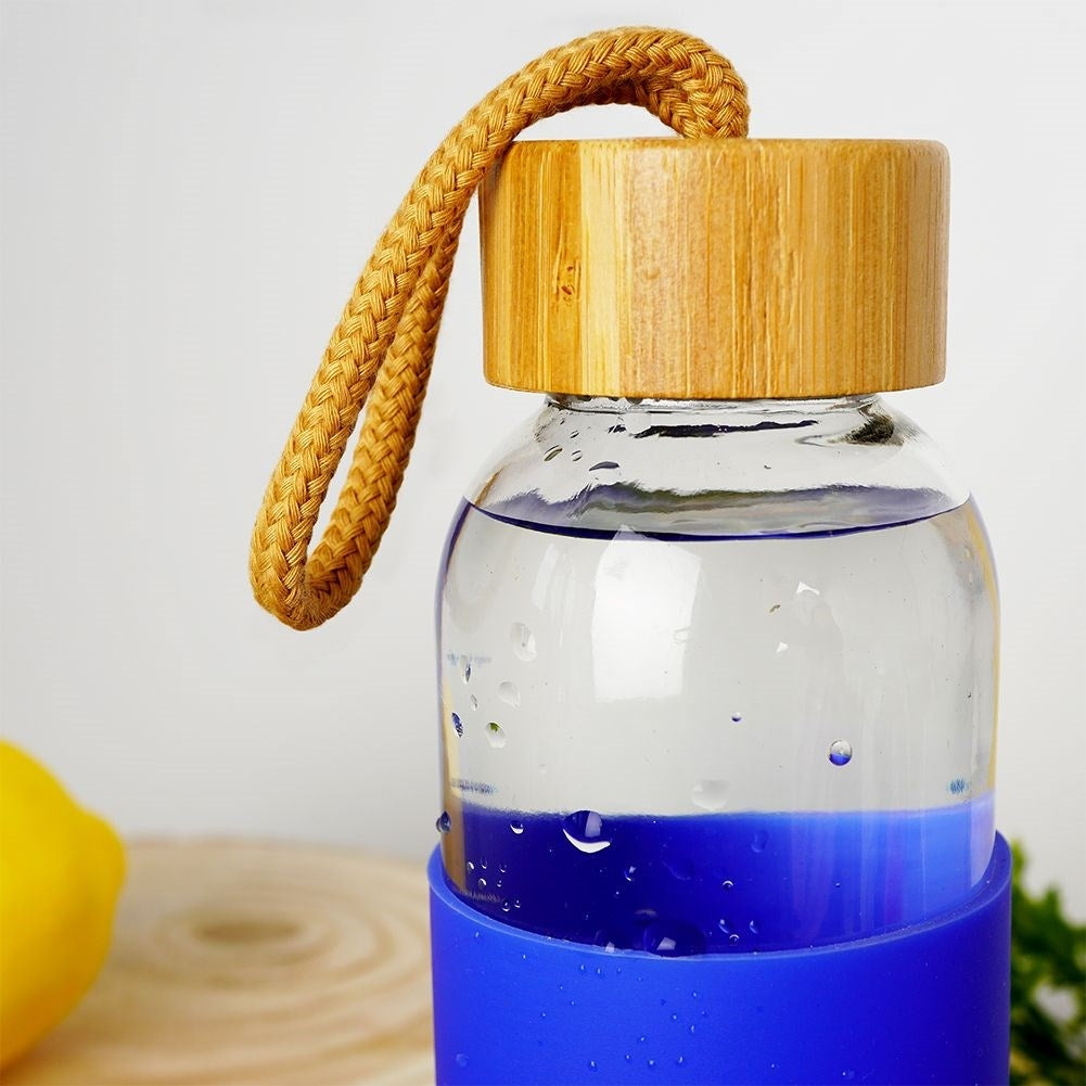 Glass bottle with silicone protection and wooden cork for drinks