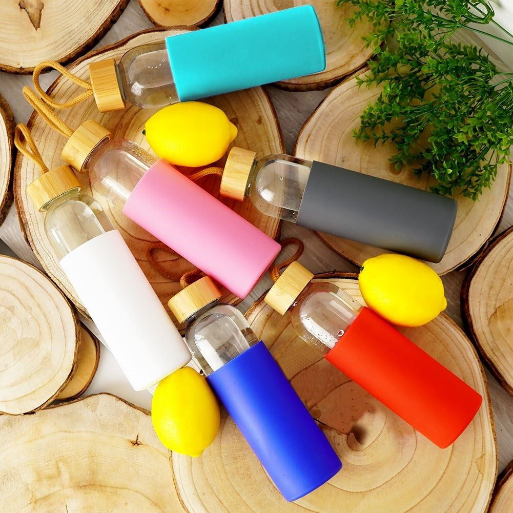 Glass bottle with silicone protection and wooden cork for drinks