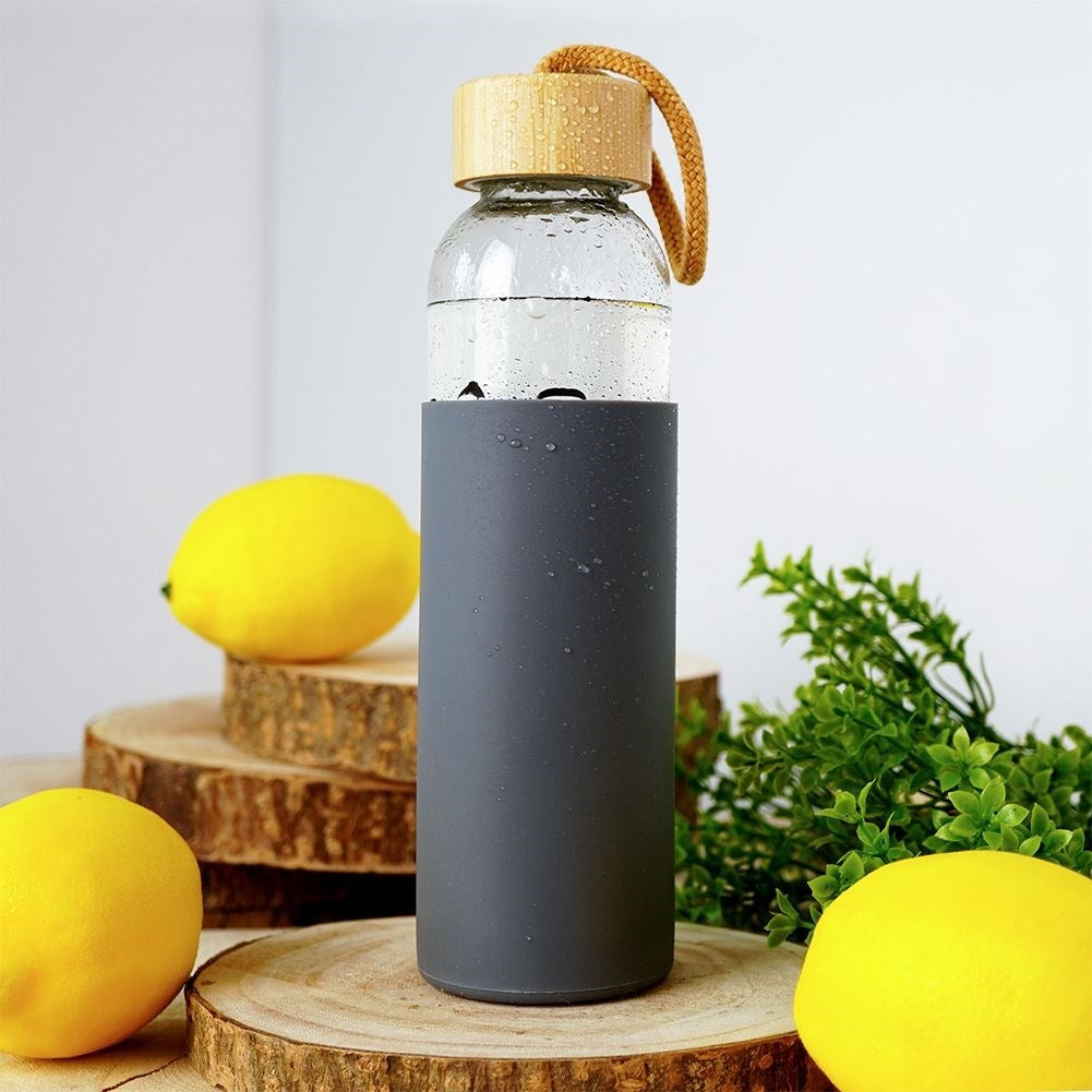 Glass bottle with silicone protection and wooden cork for drinks