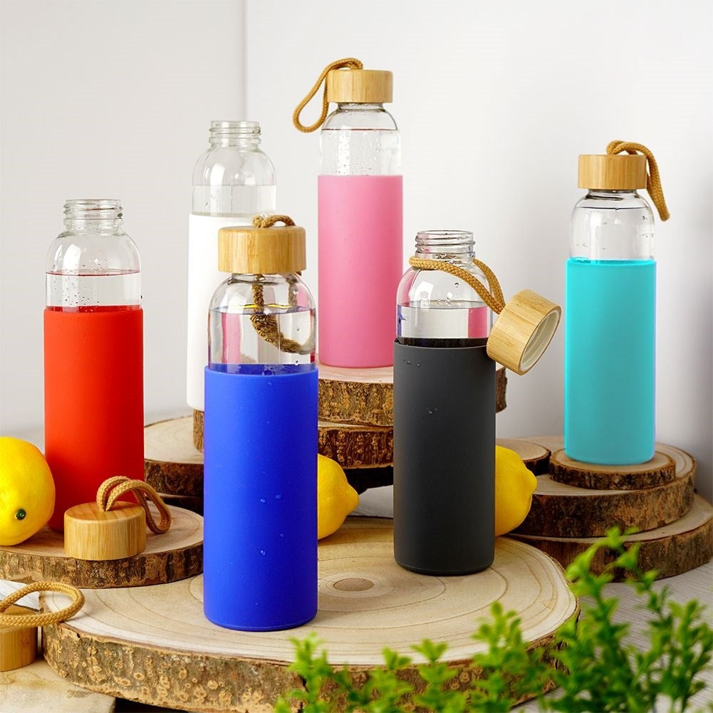 Glass bottle with silicone protection and wooden cork for drinks