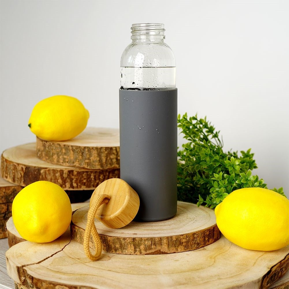 Glass bottle with silicone protection and wooden cork for drinks