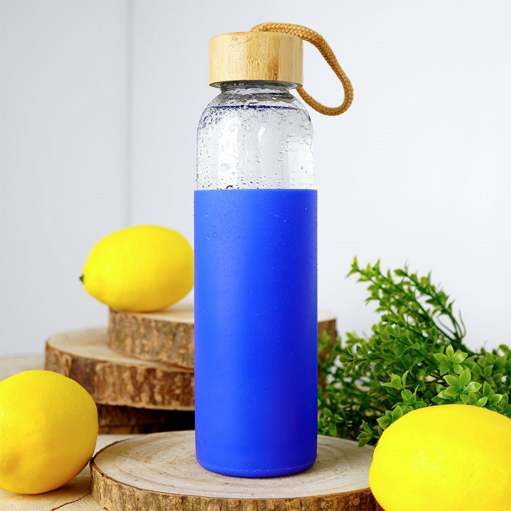 Glass bottle with silicone protection and wooden cork for drinks