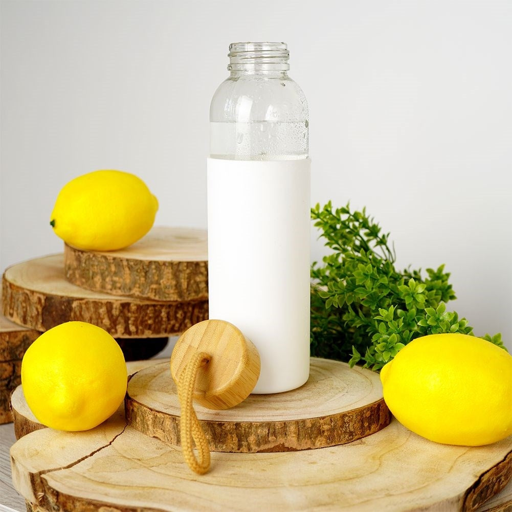Glass bottle with silicone protection and wooden lid for drinks
