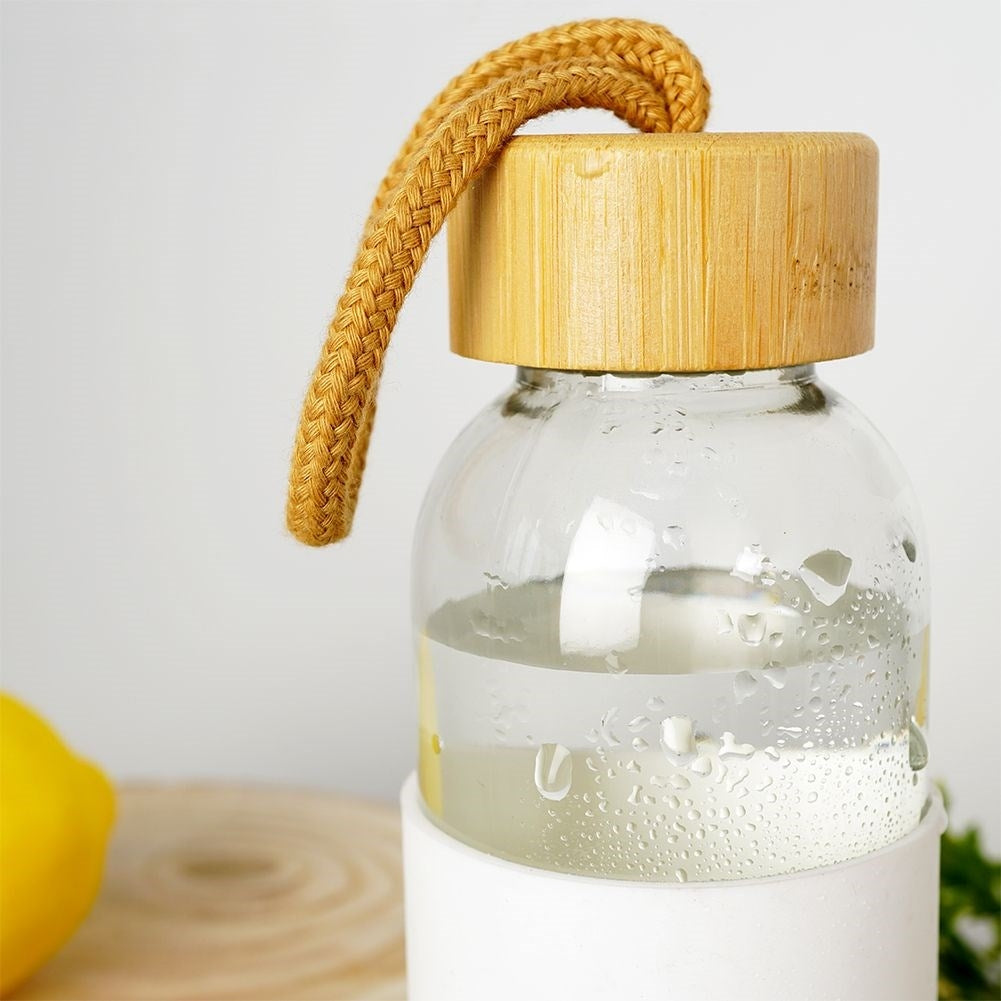 Glass bottle with silicone protection and wooden lid for drinks