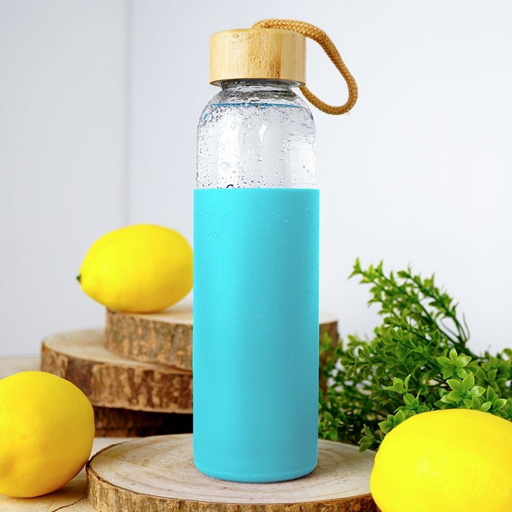 Glass bottle with silicone protection and wooden lid for drinks