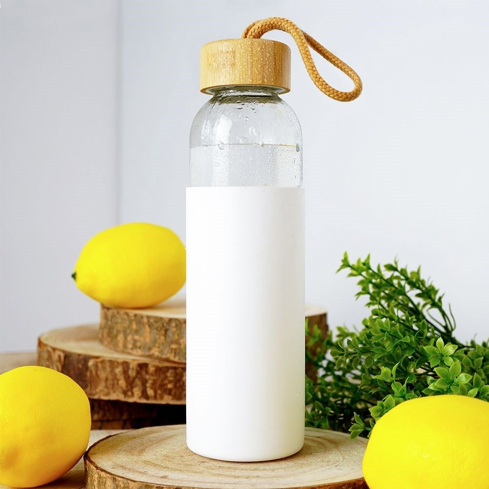 Glass bottle with silicone protection and wooden lid for drinks