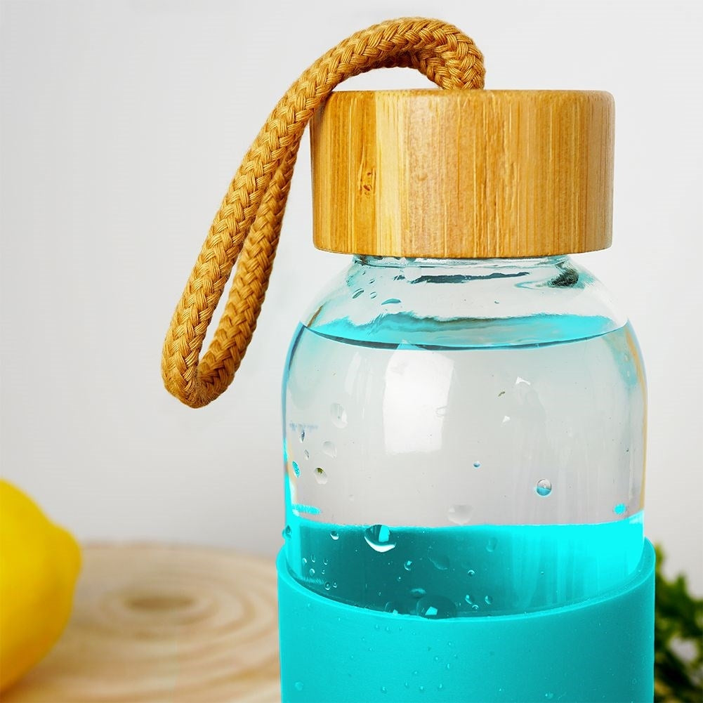 Glass bottle with silicone protection and wooden lid for drinks