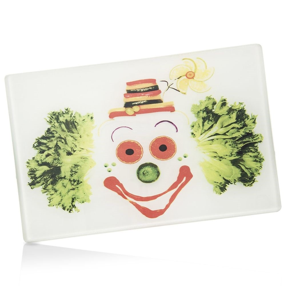 Glass cutting board with colorful clown motif and non-slip feet