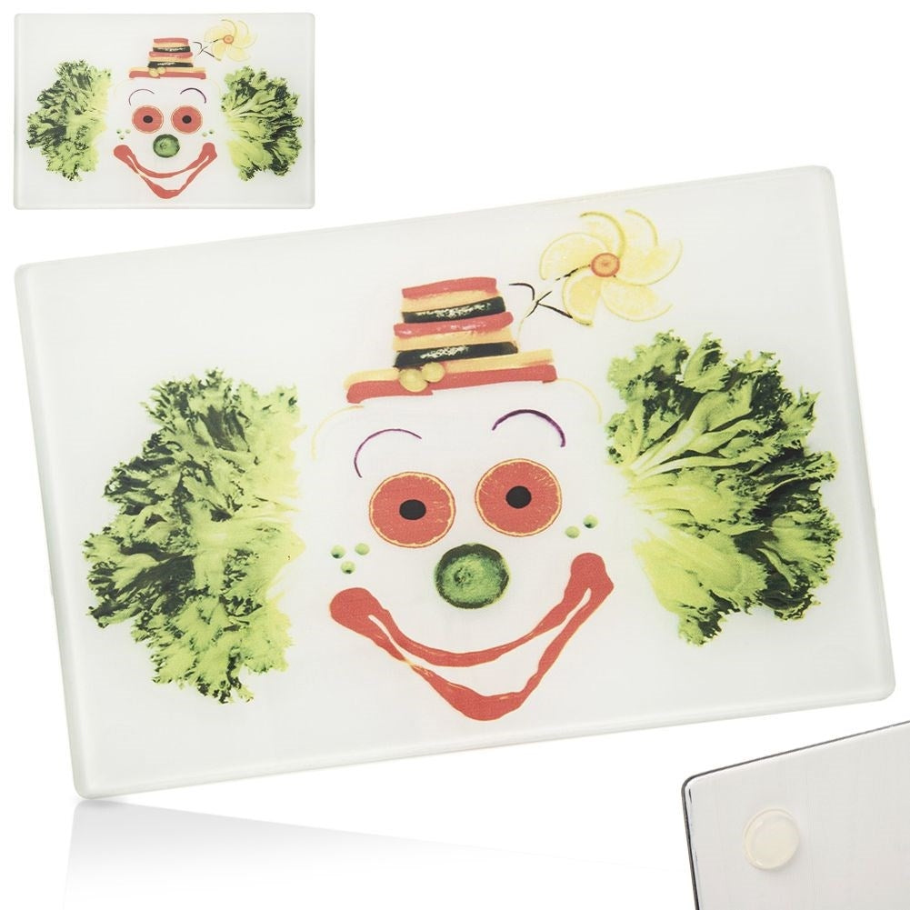 Glass cutting board with colorful clown motif and non-slip feet
