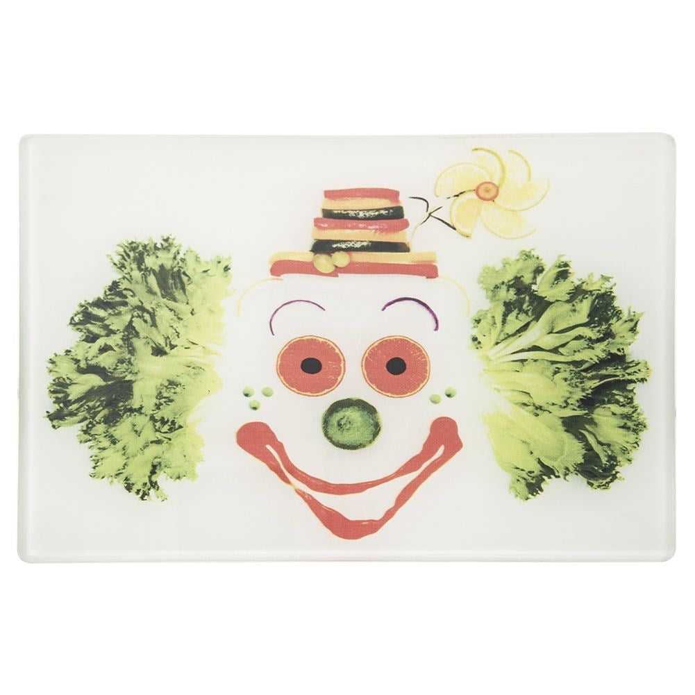 Glass cutting board with colorful clown motif and non-slip feet