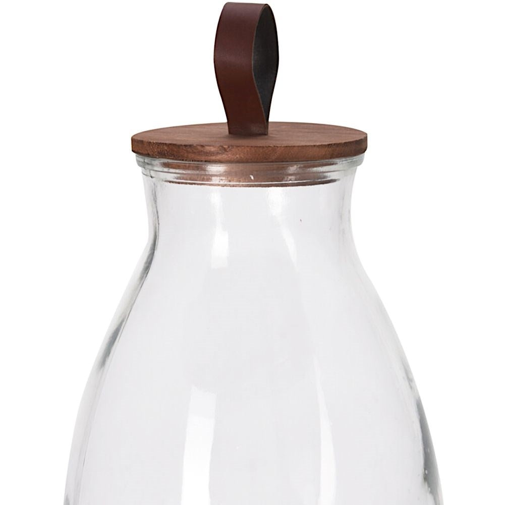 Glass jar with tap and wooden stand for drinks