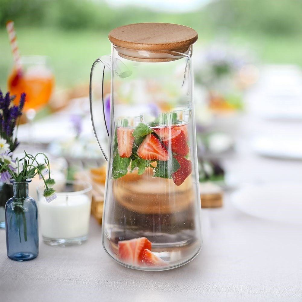 Glass jug for all drinks with handle, pouring spout and bamboo lid