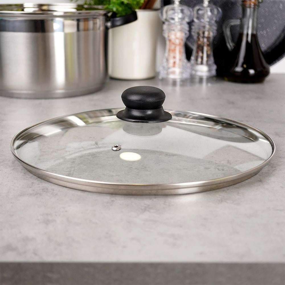 Glass lid with steel edge, plastic grip and steam outlet