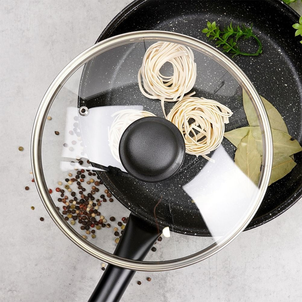 Glass lid with steel rim and plastic handle, steam valve