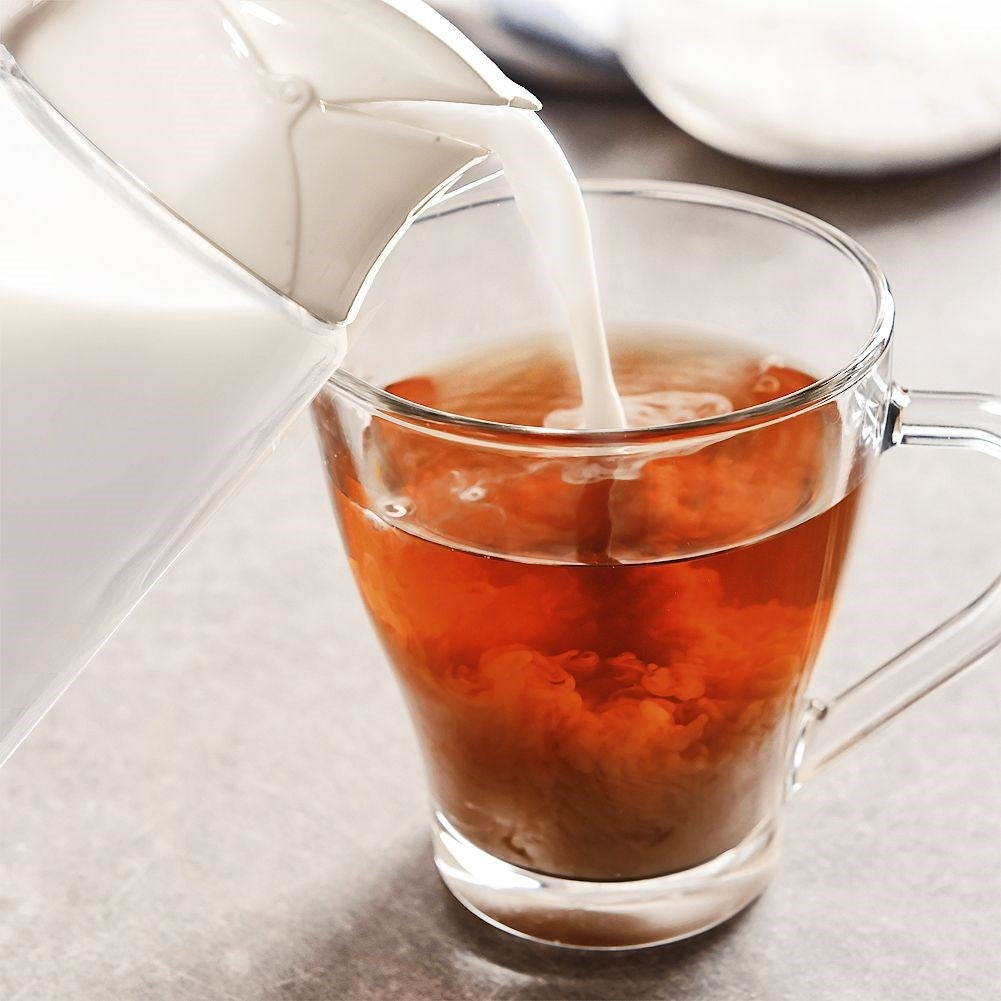 Glass milk jug with handle and spring lid for precise measurement