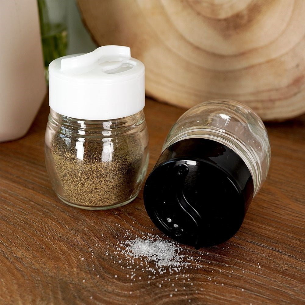 Glass salt and pepper shakers with adjustable openings