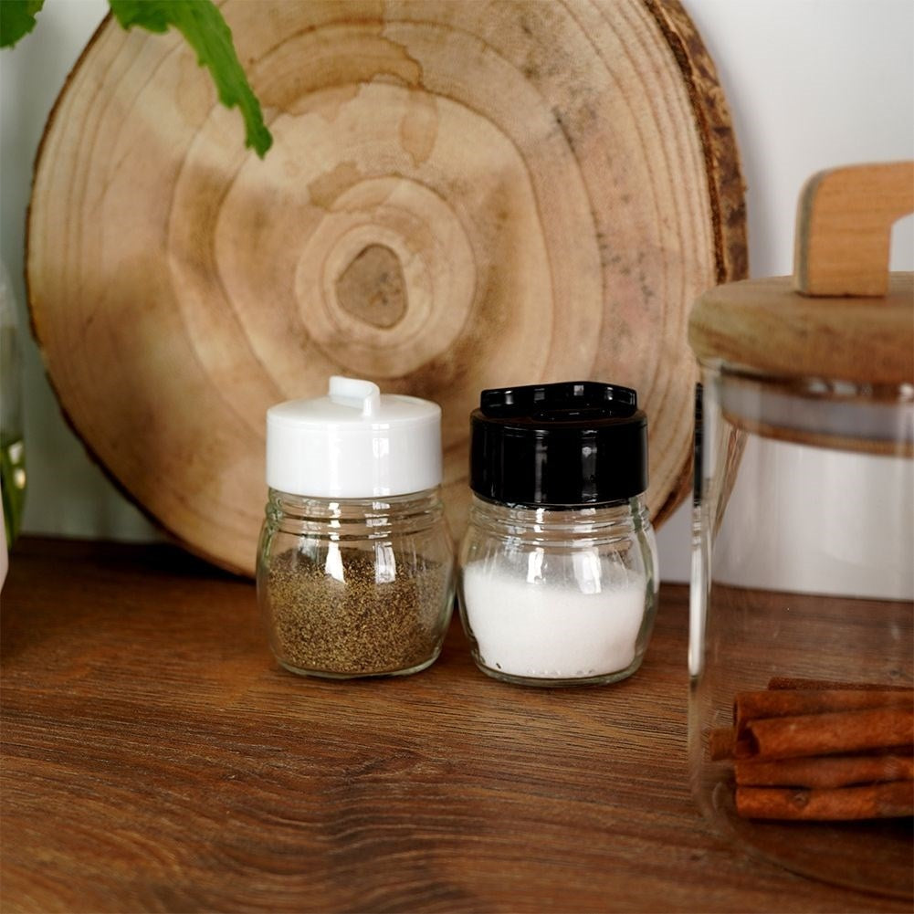 Glass salt and pepper shakers with adjustable openings