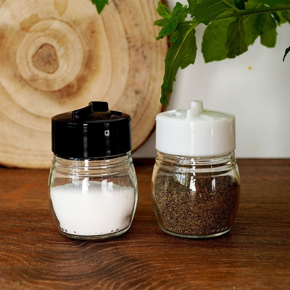 Glass salt and pepper shakers with adjustable openings