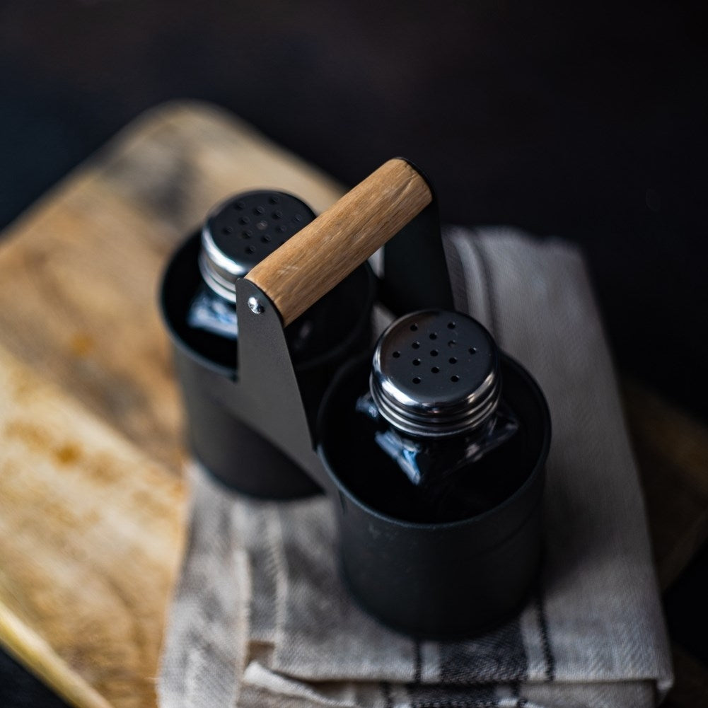 Glass salt and pepper shakers with metal stand and handle