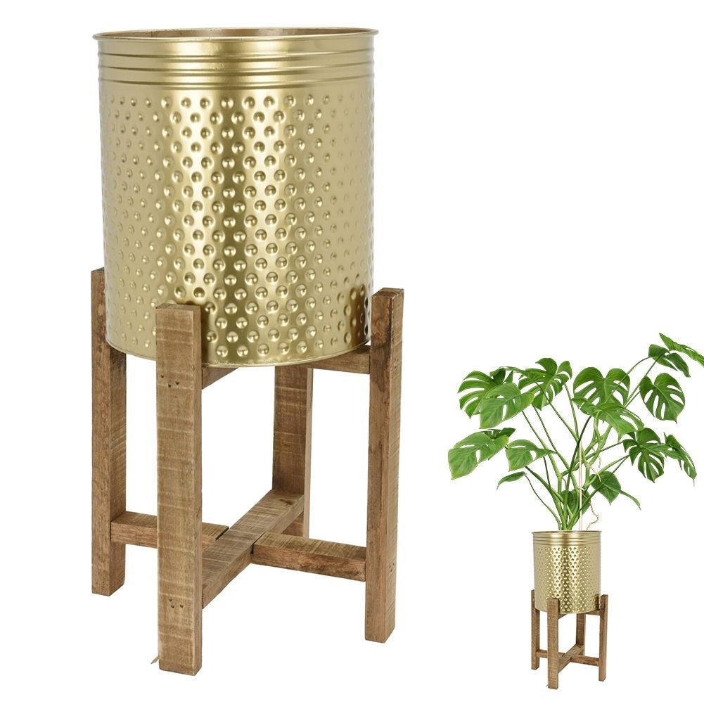 Gold colored flower pot on a wooden stand